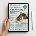 A hand holds a tablet displaying the cover of 'The At-Home Cat Nursing & Recovery Protocol' guide. The tablet screen shows a cat resting on a blanket, with white and teal text and graphics.